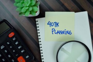 401K planning words on a post-it note next to a plant